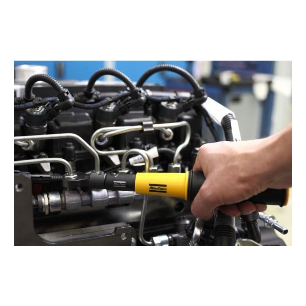 Close-up of a hand holding a yellow and black torque wrench