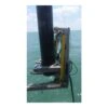 כלי חיתוך גדול ליד עמוד מעל הים - Large cutting tool beside a column above water
