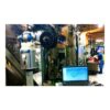 מכונת מדידת קצות צינור ליד מסך מחשב - Pipe end measurement machine beside a computer screen