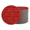 A stack of red and gray round discs, with the top disc shown front-on