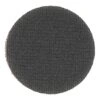 Close-up of a dark round disc with a very coarse textured surface on a white