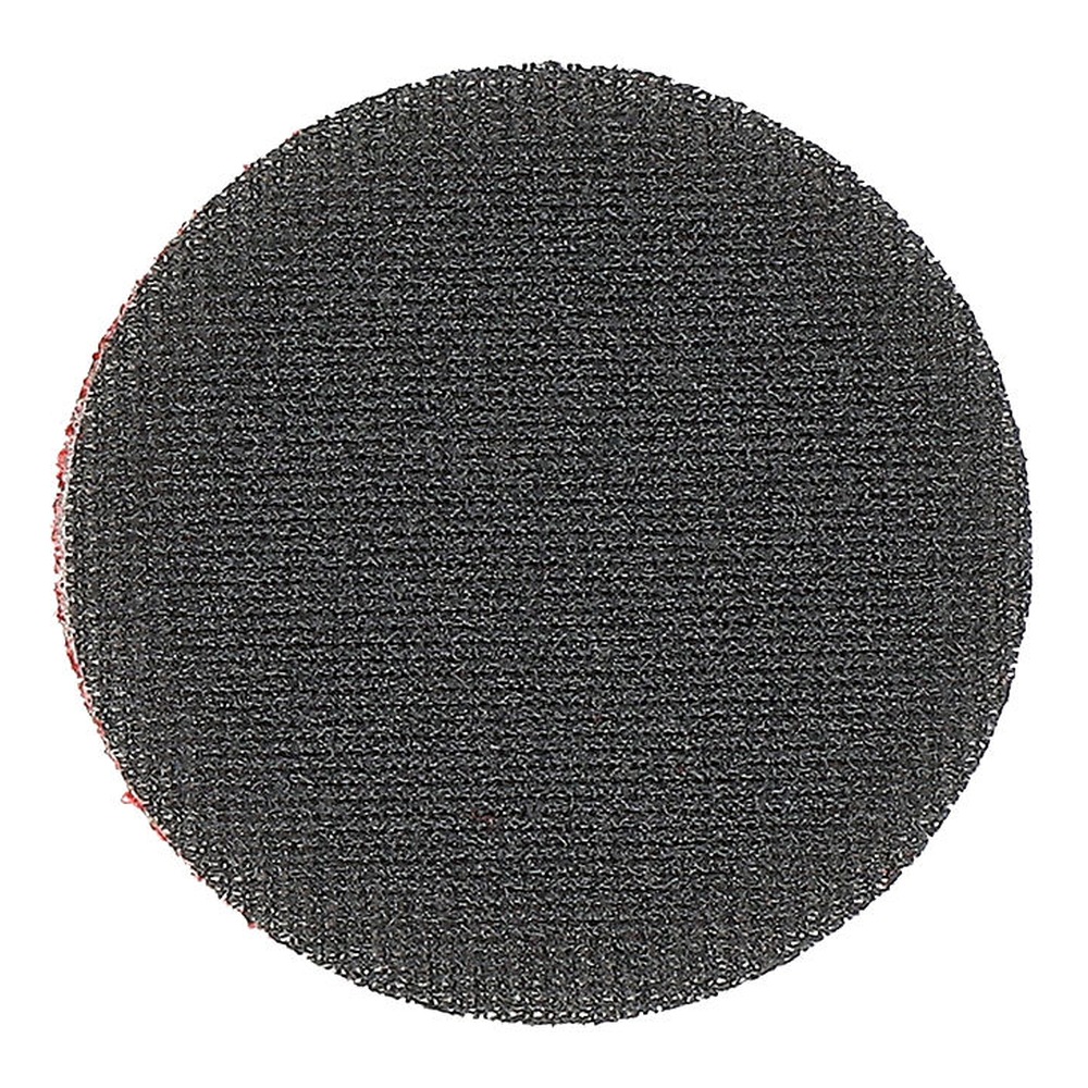 Close-up of a dark round disc with a very coarse textured surface on a white
