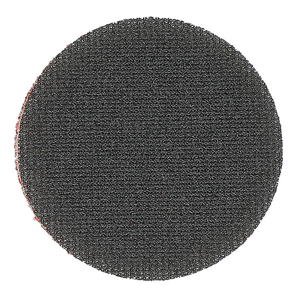 Close-up of a dark round disc with a very coarse textured surface on a white