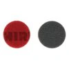 Two round discs on a white background - one red and one dark gray, shown