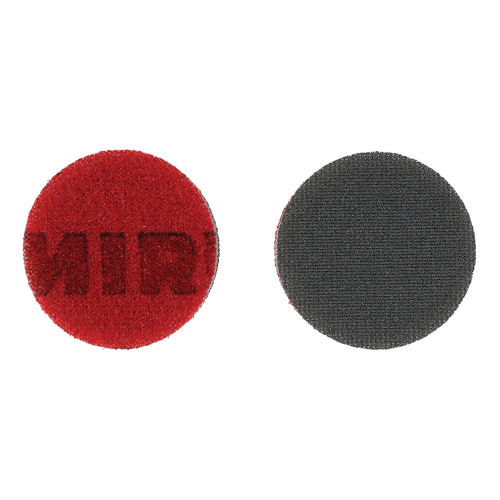 Two round discs on a white background - one red and one dark gray, shown