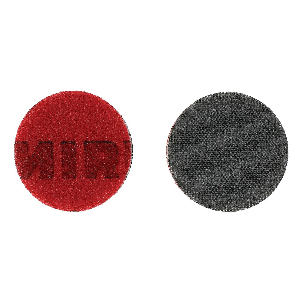 Two round discs on a white background - one red and one dark gray, shown