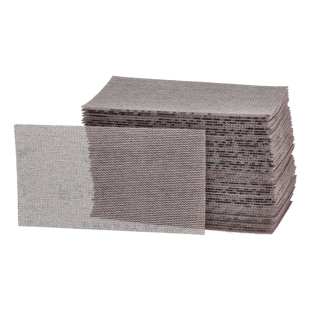 A stack of rectangular brown-gray mesh sanding sheets, with one sheet placed
