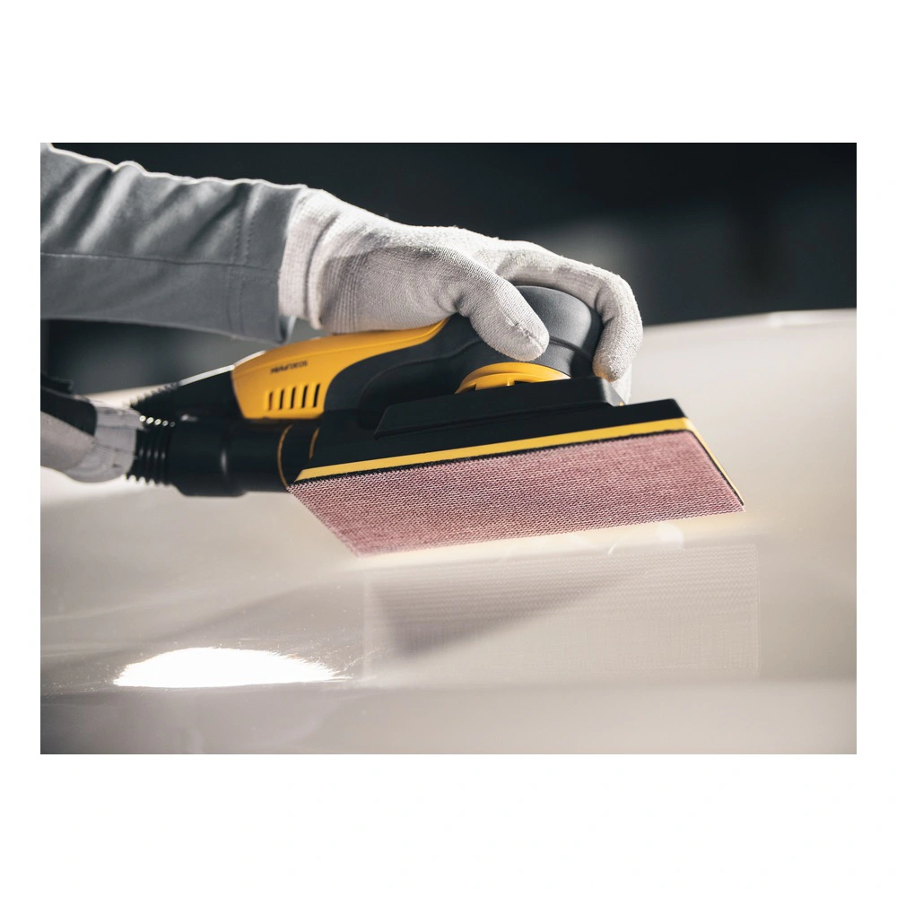 A close-up of a yellow-and-black hand sander with a mesh sanding pad