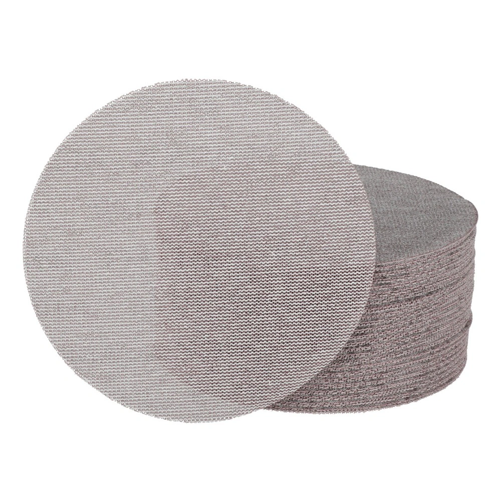 A stack of round sanding discs with one disc placed in front, on a white