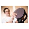 A person is holding and showing a round sanding disc attached to a sander