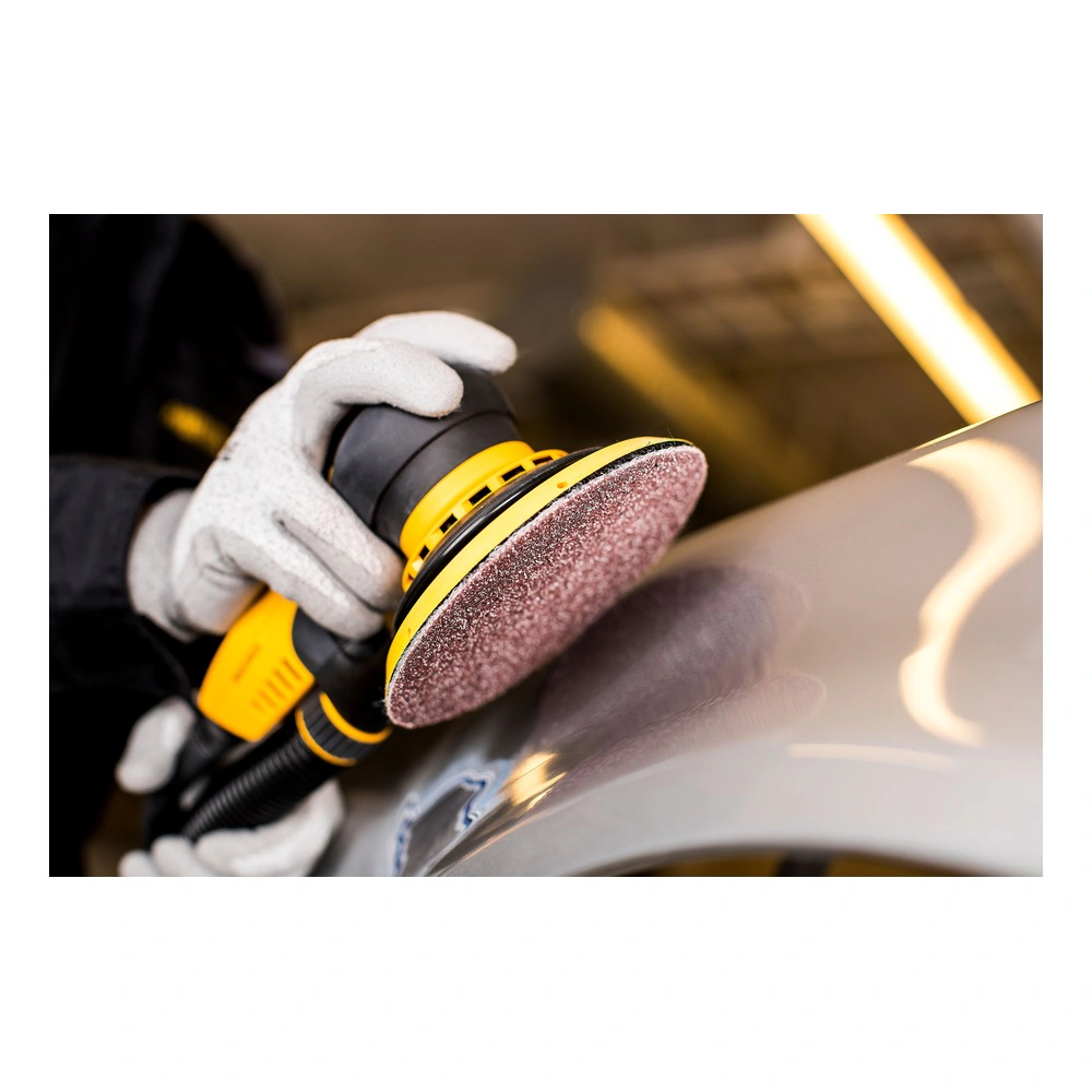 Application scene of a hand sander with a mesh sanding disc against a curved