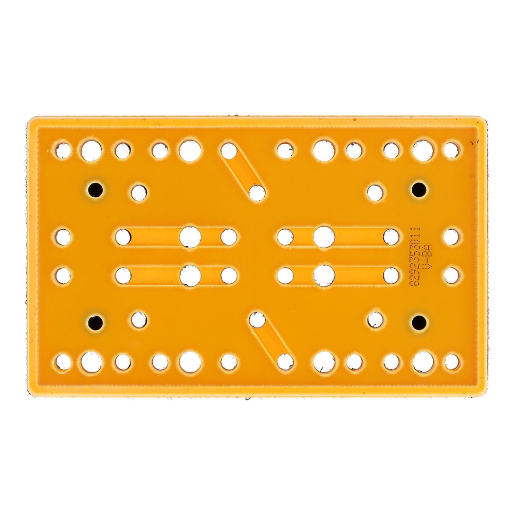 Underside view of a rectangular orange pad with many rows of round holes