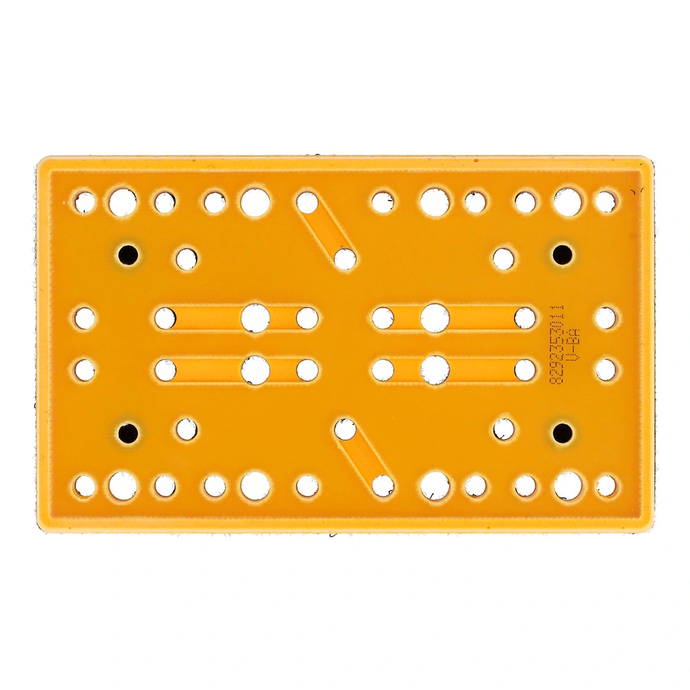 Underside view of a rectangular orange pad with many rows of round holes