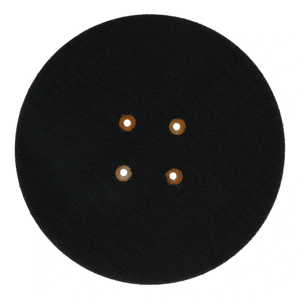 Round black textured pad with a woven surface and four small holes arranged
