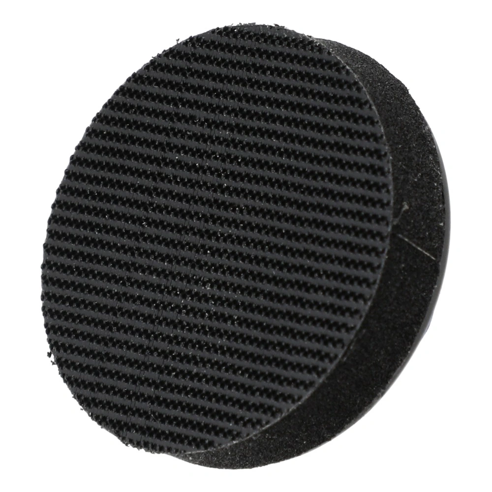 Two overlapping black round disks, with the front one having a rough