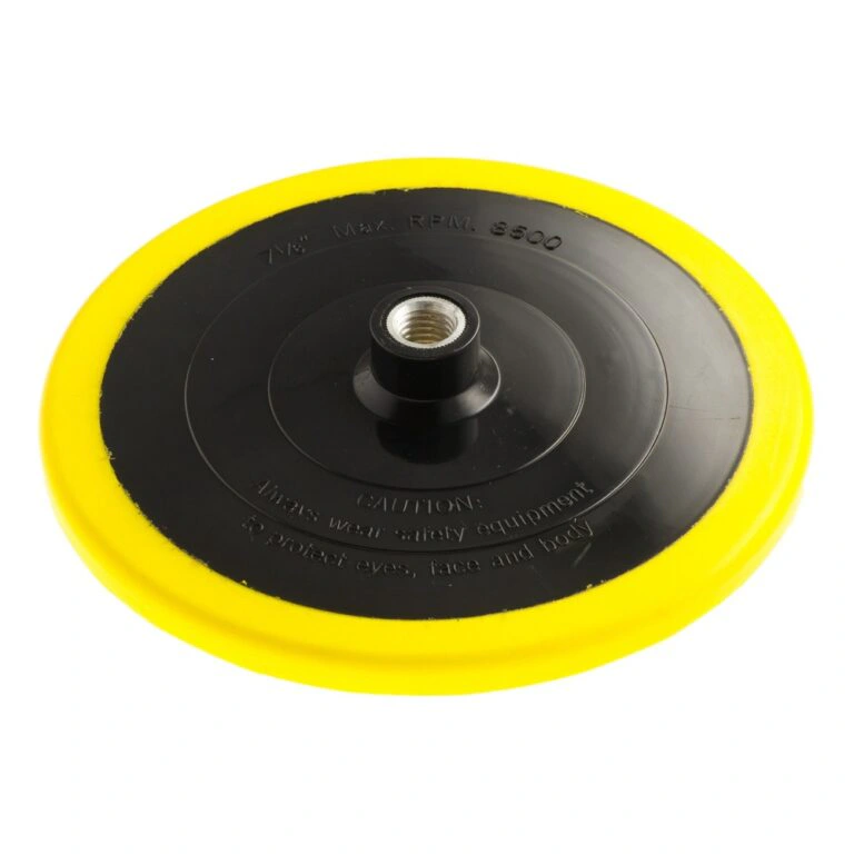 Product view of a round black backing pad with a yellow edge and a metal