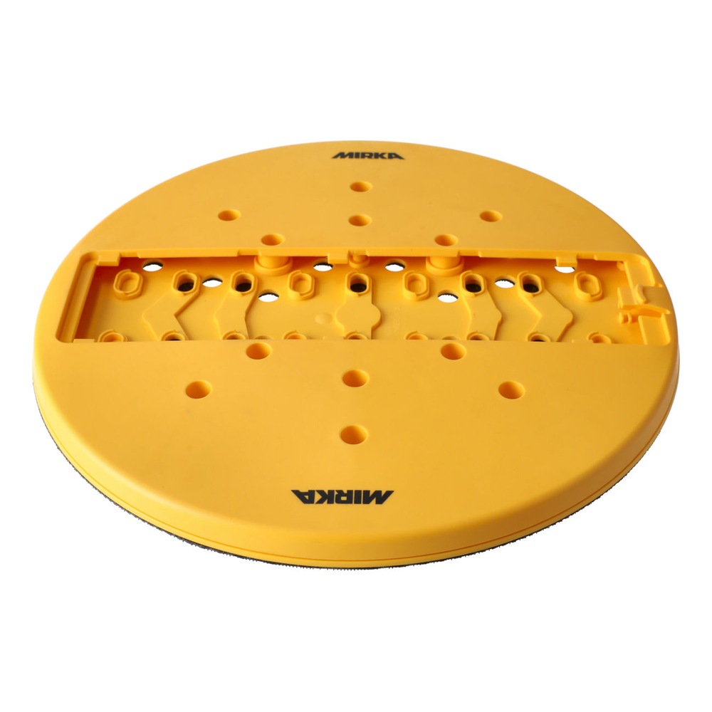 A round yellow-orange sanding pad with many holes, shown from a low angle