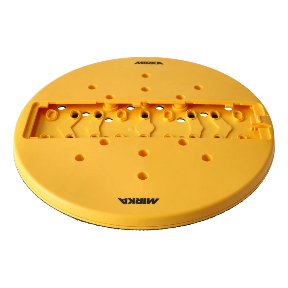A round yellow-orange sanding pad with many holes, shown from a low angle