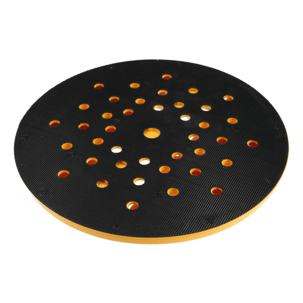 A round black sanding pad with many holes and some holes showing orange