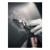 Another close-up of a gloved hand and sanding sheet on a curved black