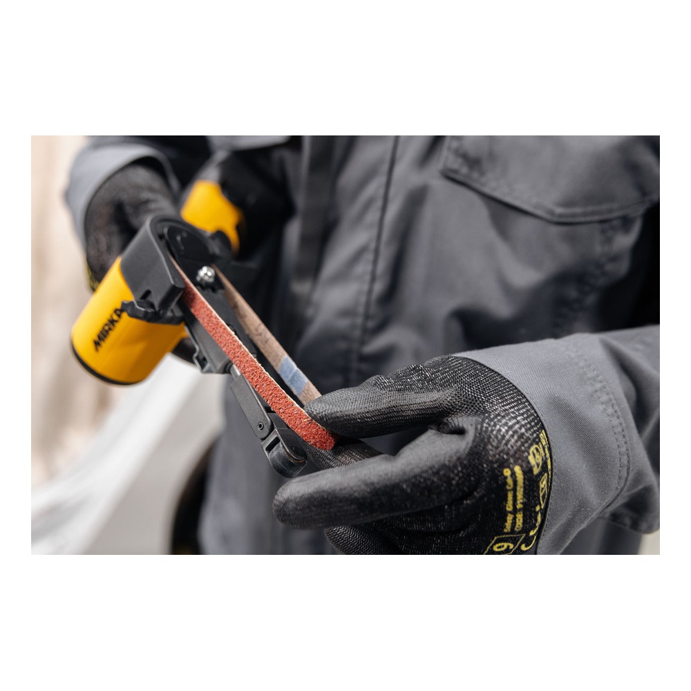 A gloved person holding a cordless file belt sander with the abrasive belt