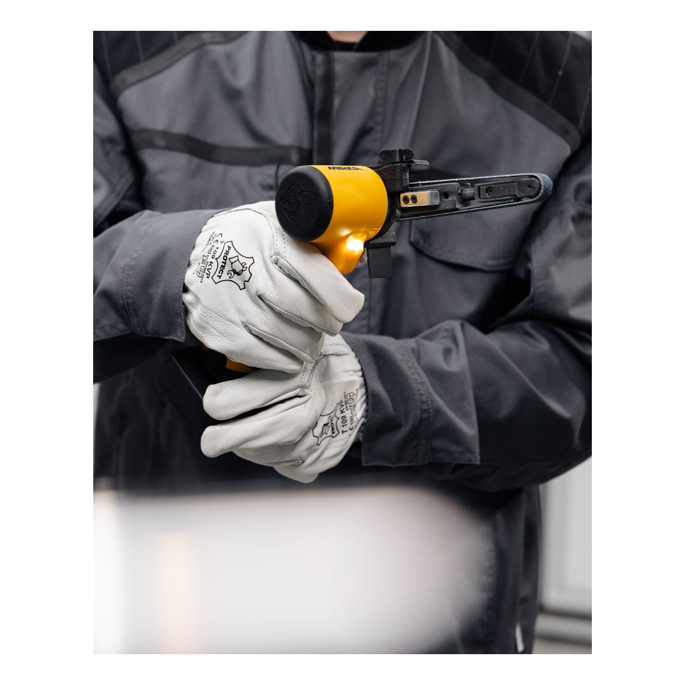 A gloved person holding a compact cordless file belt sander in a front-side