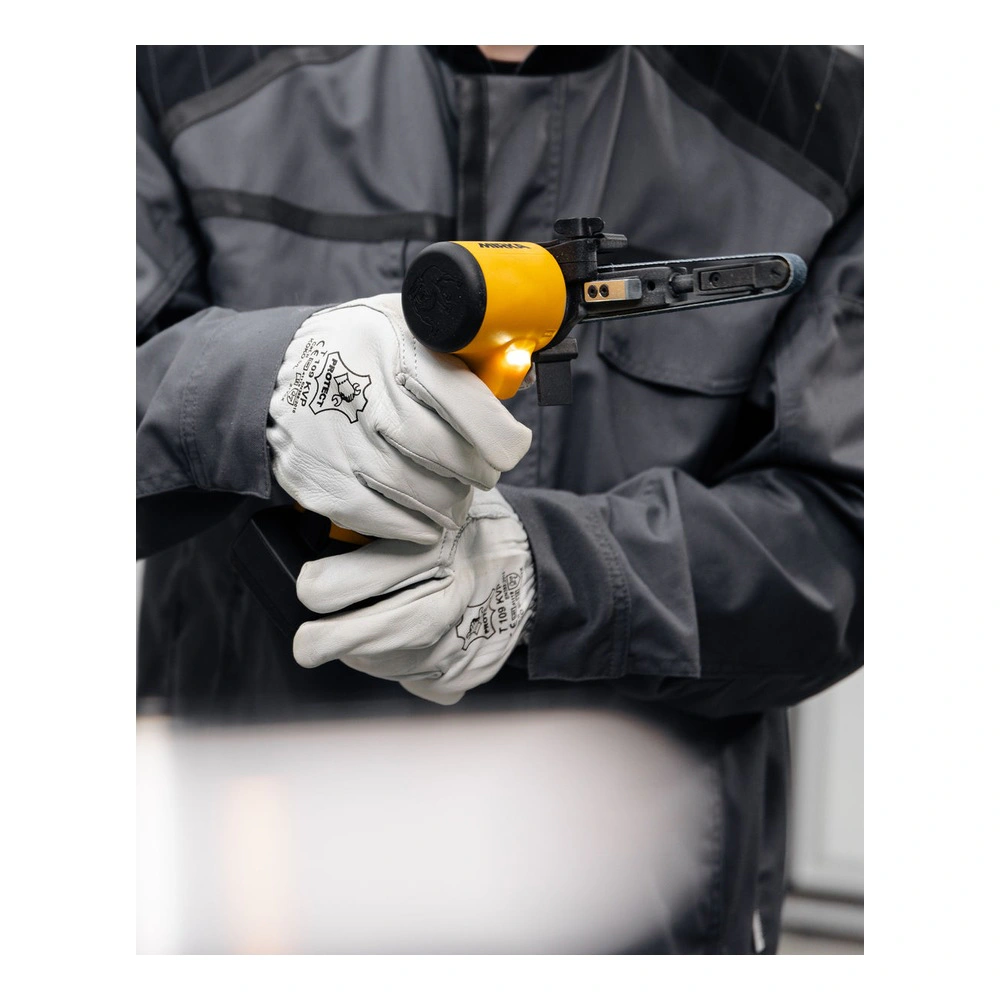 A gloved person holding a compact cordless file belt sander in a front-side