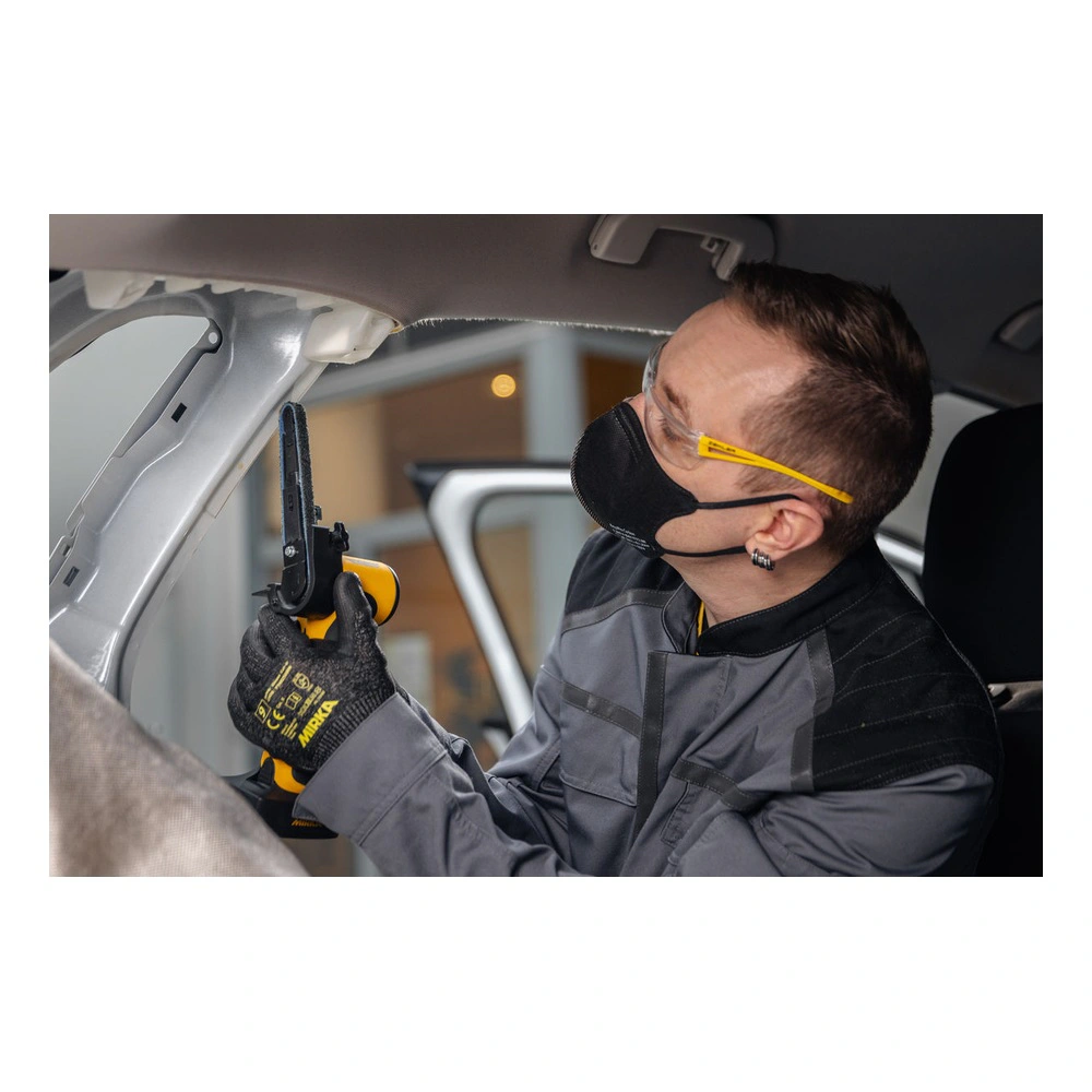 A person works inside a car interior with a yellow and black cordless file