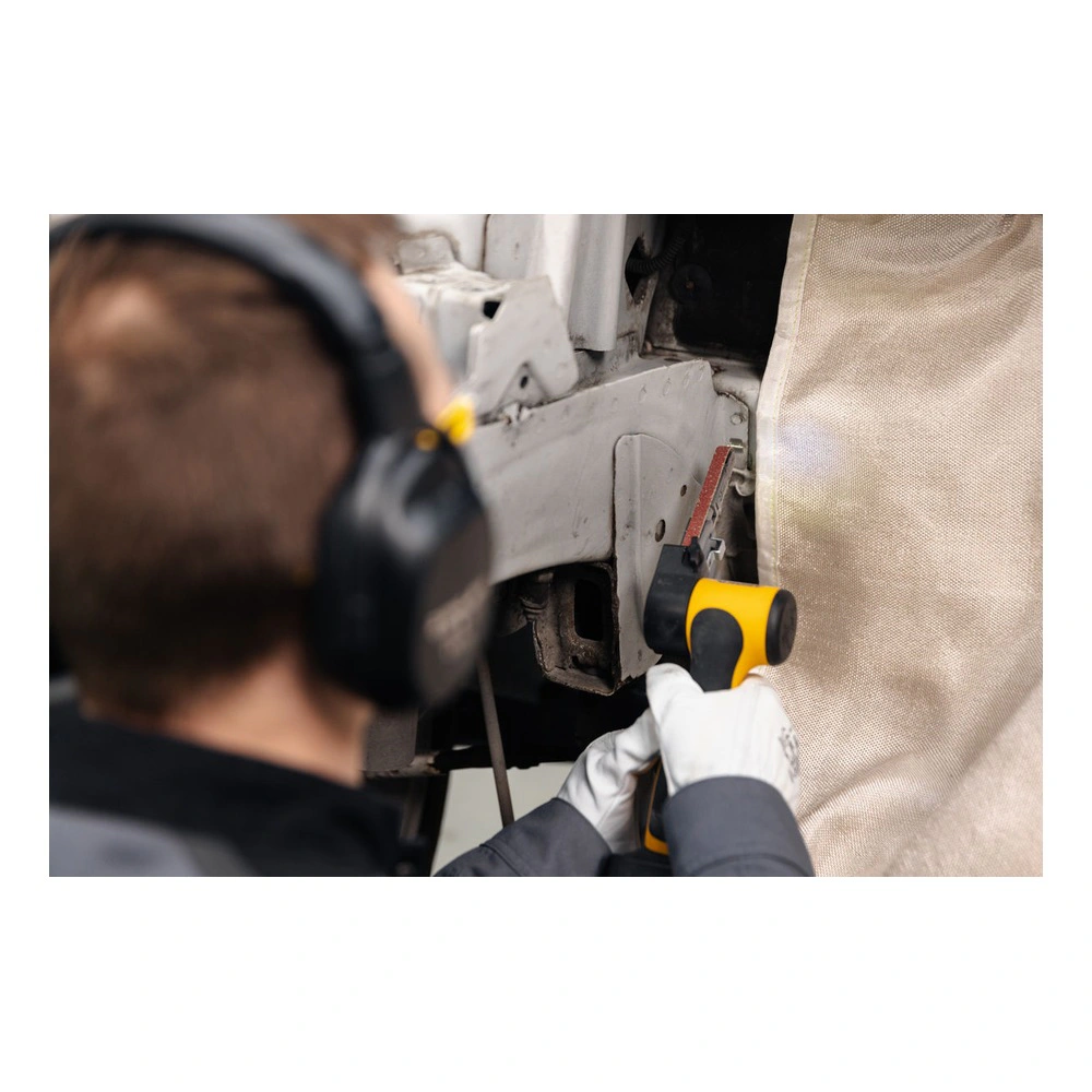 A person uses a yellow and black cordless file belt sander on a metal area