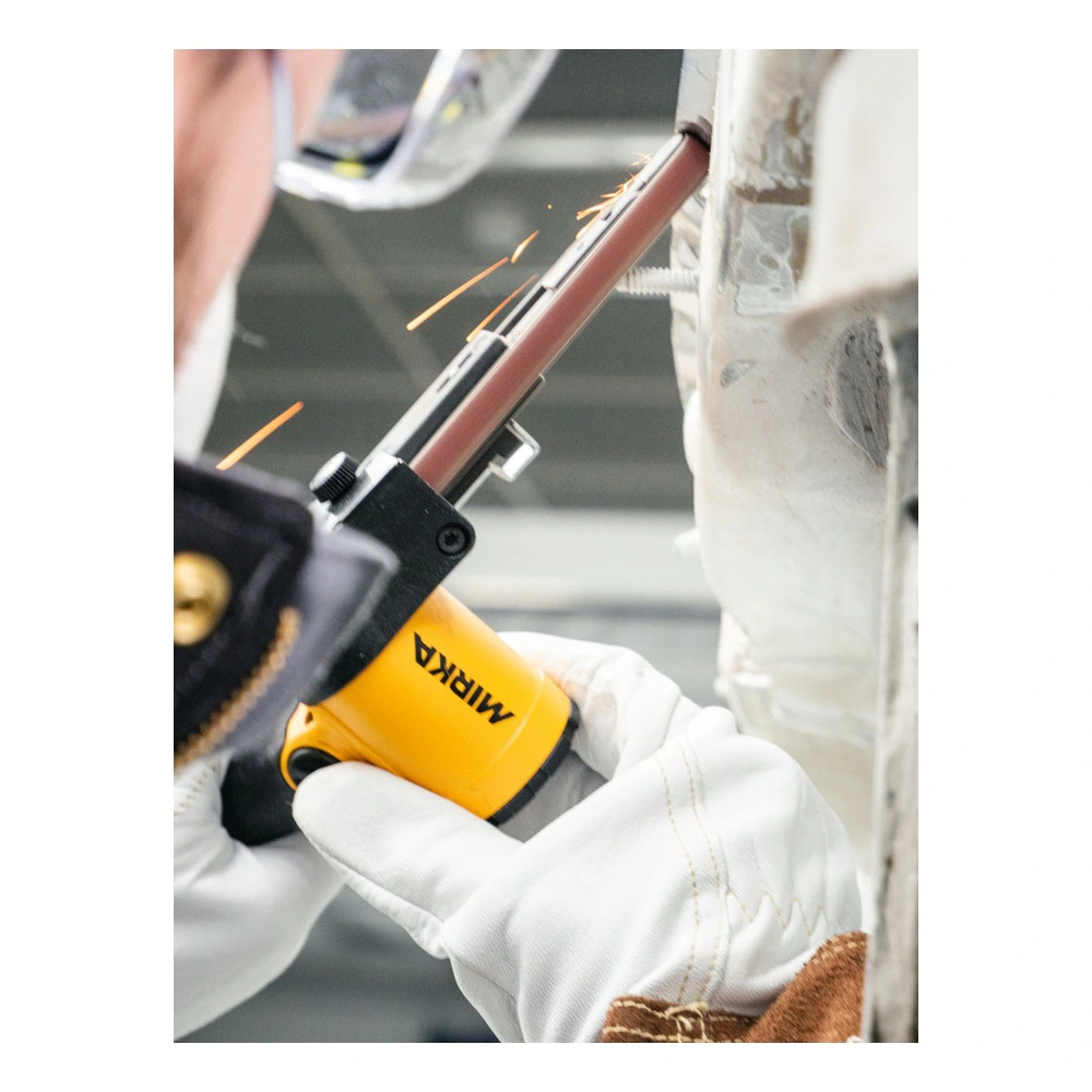 Close-up of a small yellow and black belt sanding tool in white-gloved