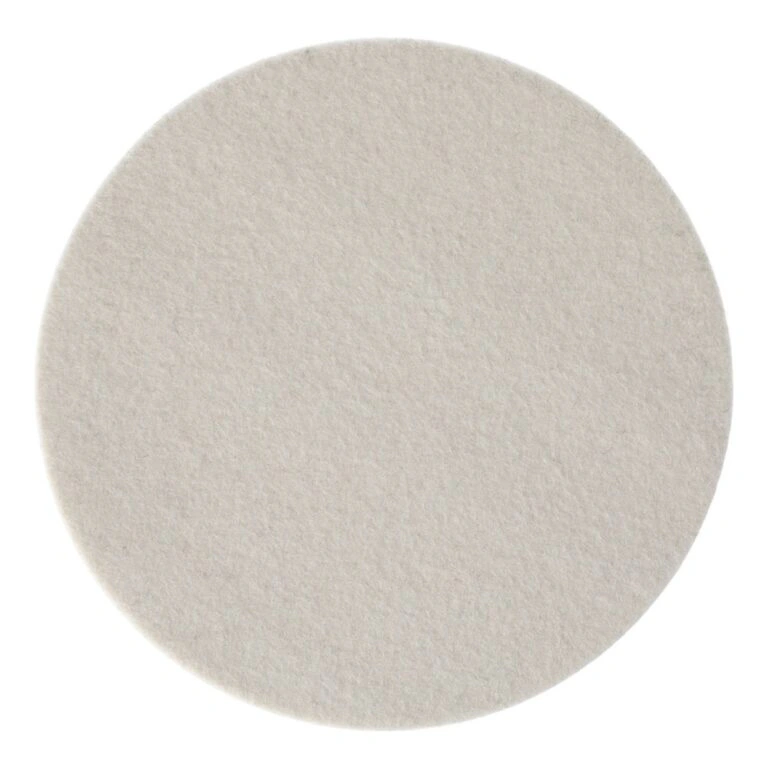 A round off-white felt pad, shown from above on a white background