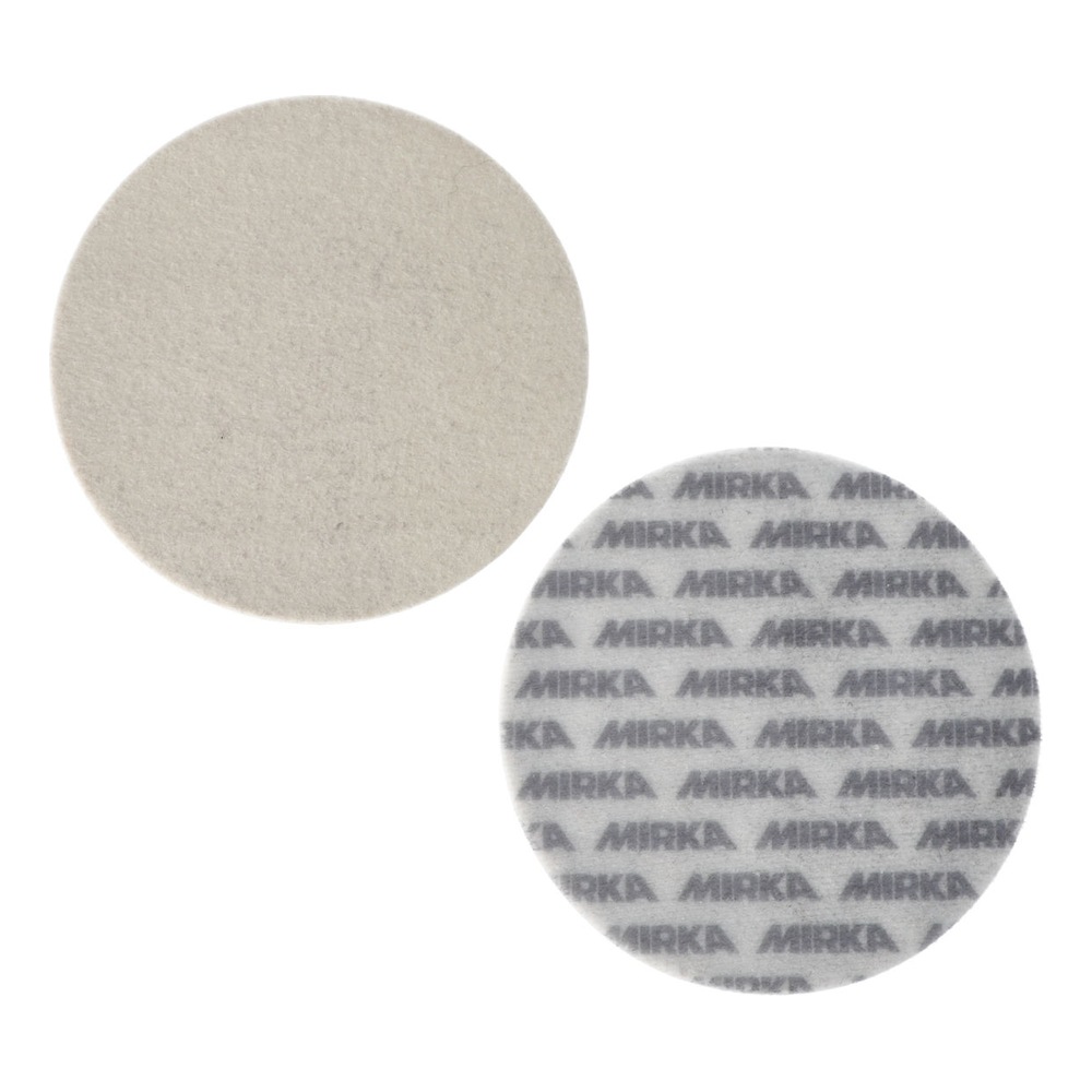 Two light-colored round pads side by side, one plain and one with MIRKA