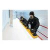 Two workers in full protective gear are sanding a white surface with a long