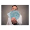 A person holds several circular sanding sheets and one perforated sheet