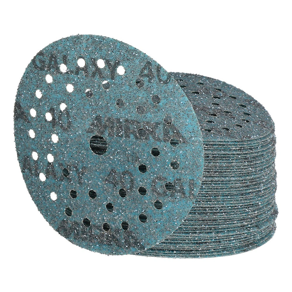 A stack of turquoise sanding discs with one disc placed in front, on a white