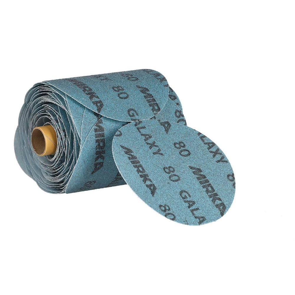 A rolled blue sanding paper strip with a detached disc in front on a white