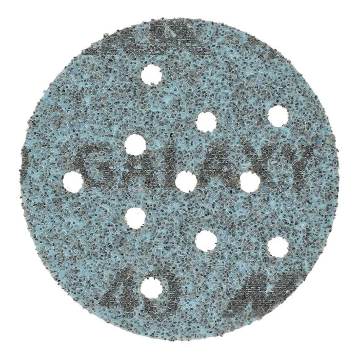 Front view of a round blue sanding disc with several dust holes on a white