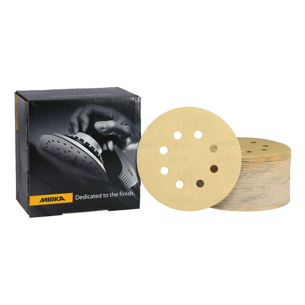 Black product box with gold sanding discs, next to a stacked pile of round