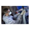 Person wearing a mask sanding a vehicle surface