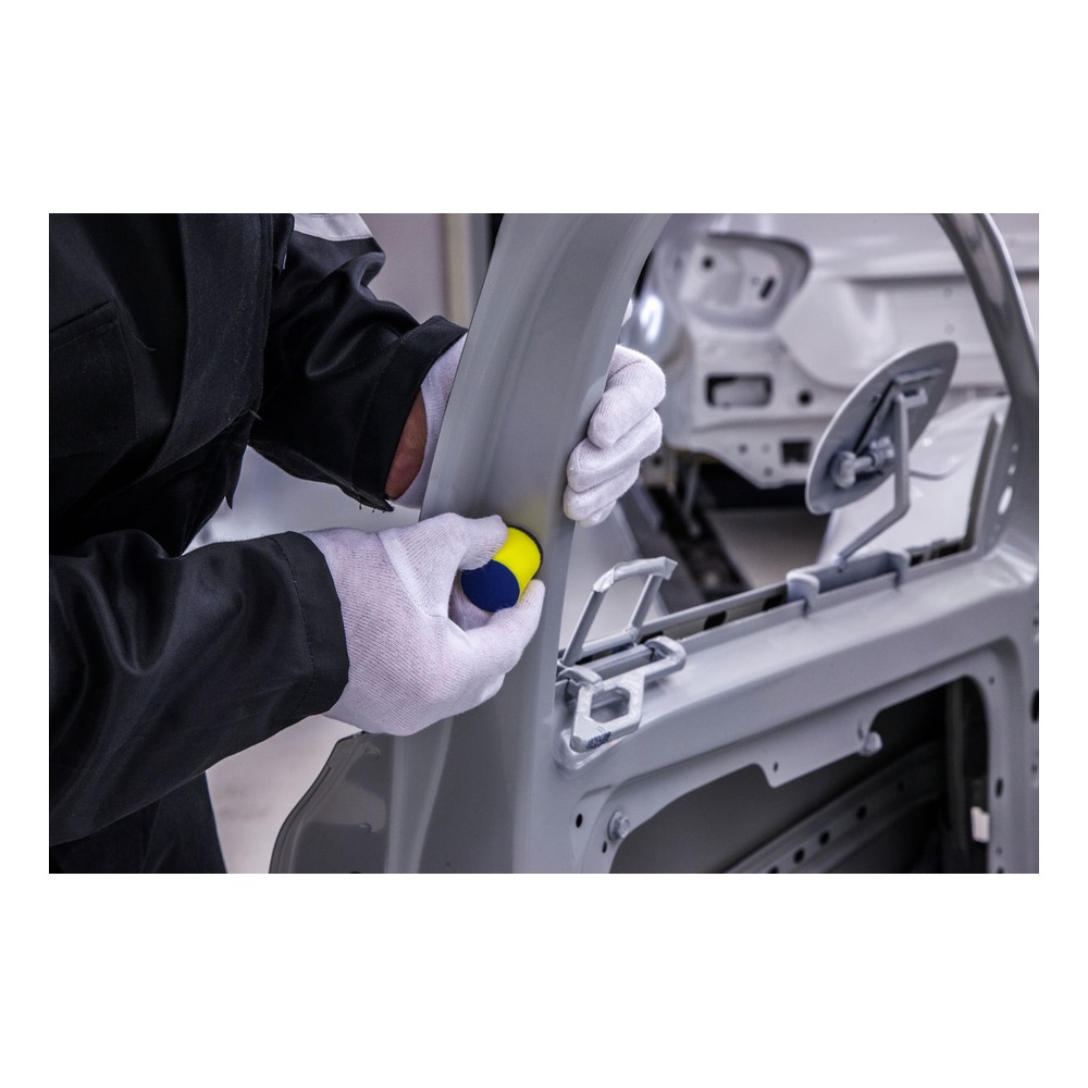 Gloved hands sanding a gray car frame