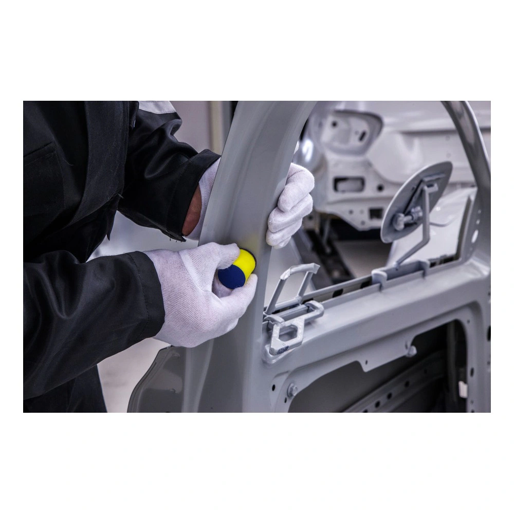 Gloved hands sanding a gray car frame