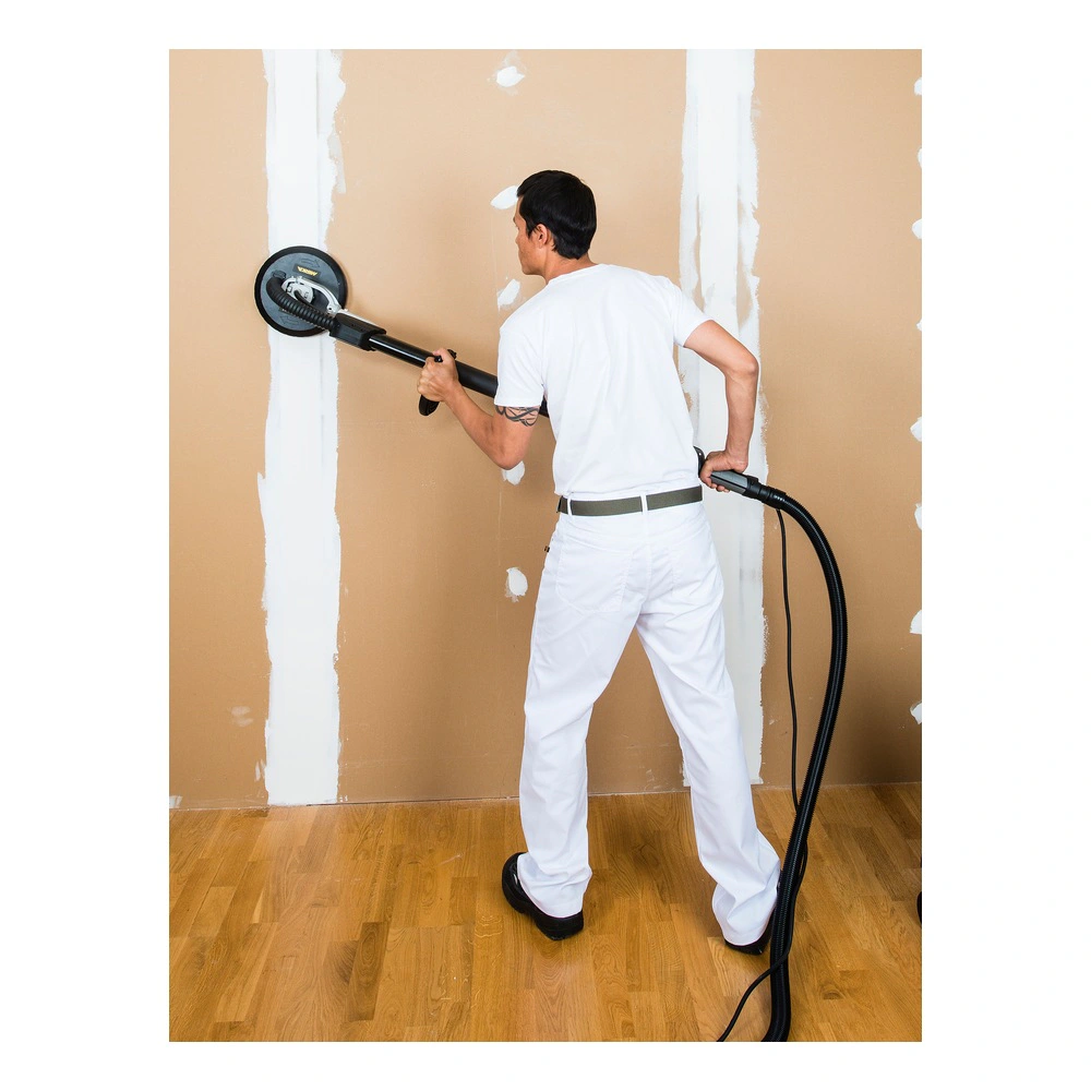 Person using a wall sander on drywall