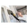 Person using triangular sander on a window frame