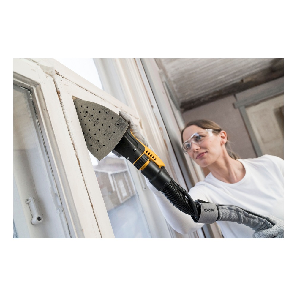 Person using triangular sander on a window frame