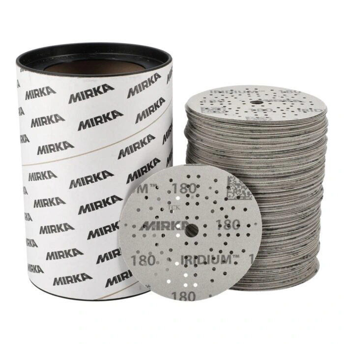 Branded cylindrical container beside a stack of sanding discs with one disc