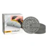 A product box beside a stack of gray round sanding discs with holes