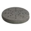 A stack of dark round sanding discs seen at an angle, with visible dust