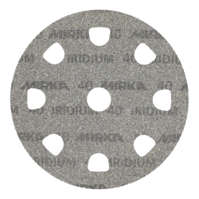 A gray round sanding disc with large arched holes and a center hole, seen