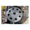 Close-up of a round perforated sanding disc mounted on a black power tool