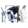 A person on scaffolding sanding a white exterior wall with a round power
